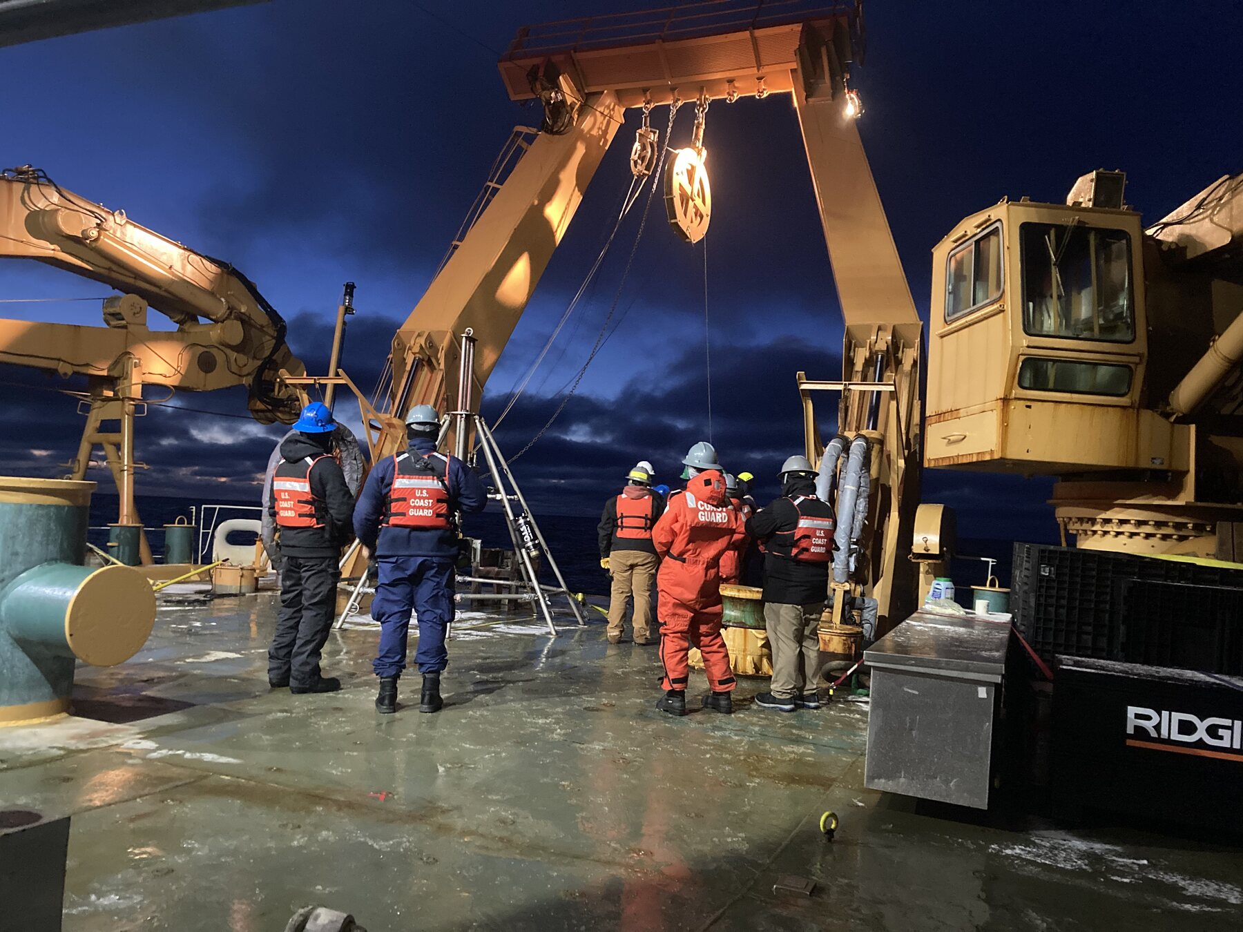 Scientists conducting nighttime deck operations aboard the USCGC Healy